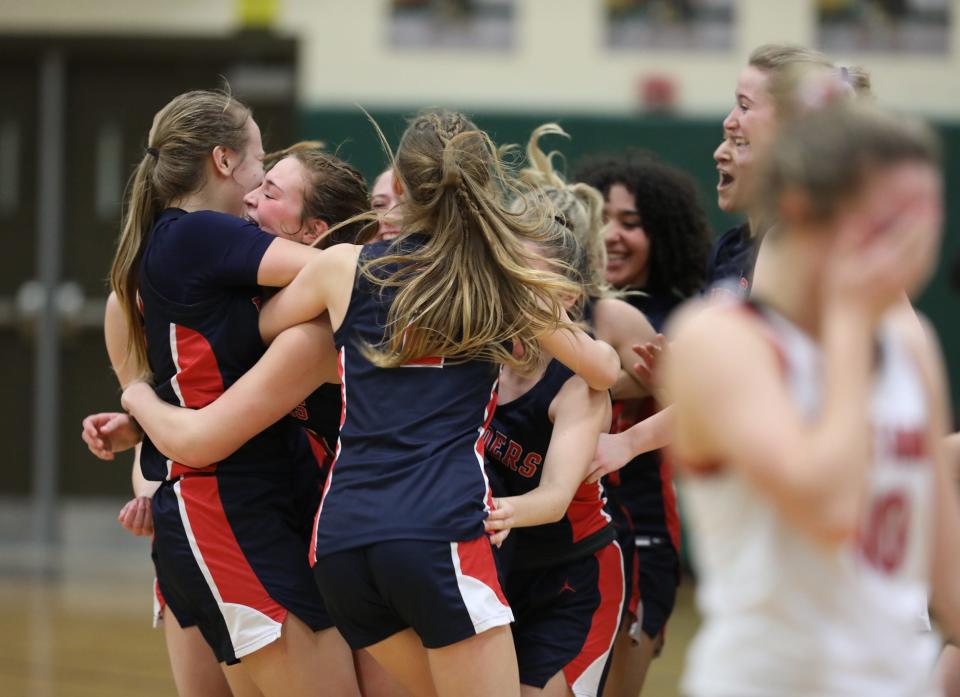 Hornell players take the floor after the buzzer.  They won their Section V Class B2 championship game at Rush Henrietta High School against Danville 54-47.  Dansville 's Megan Tyler cries as she walks off the court.