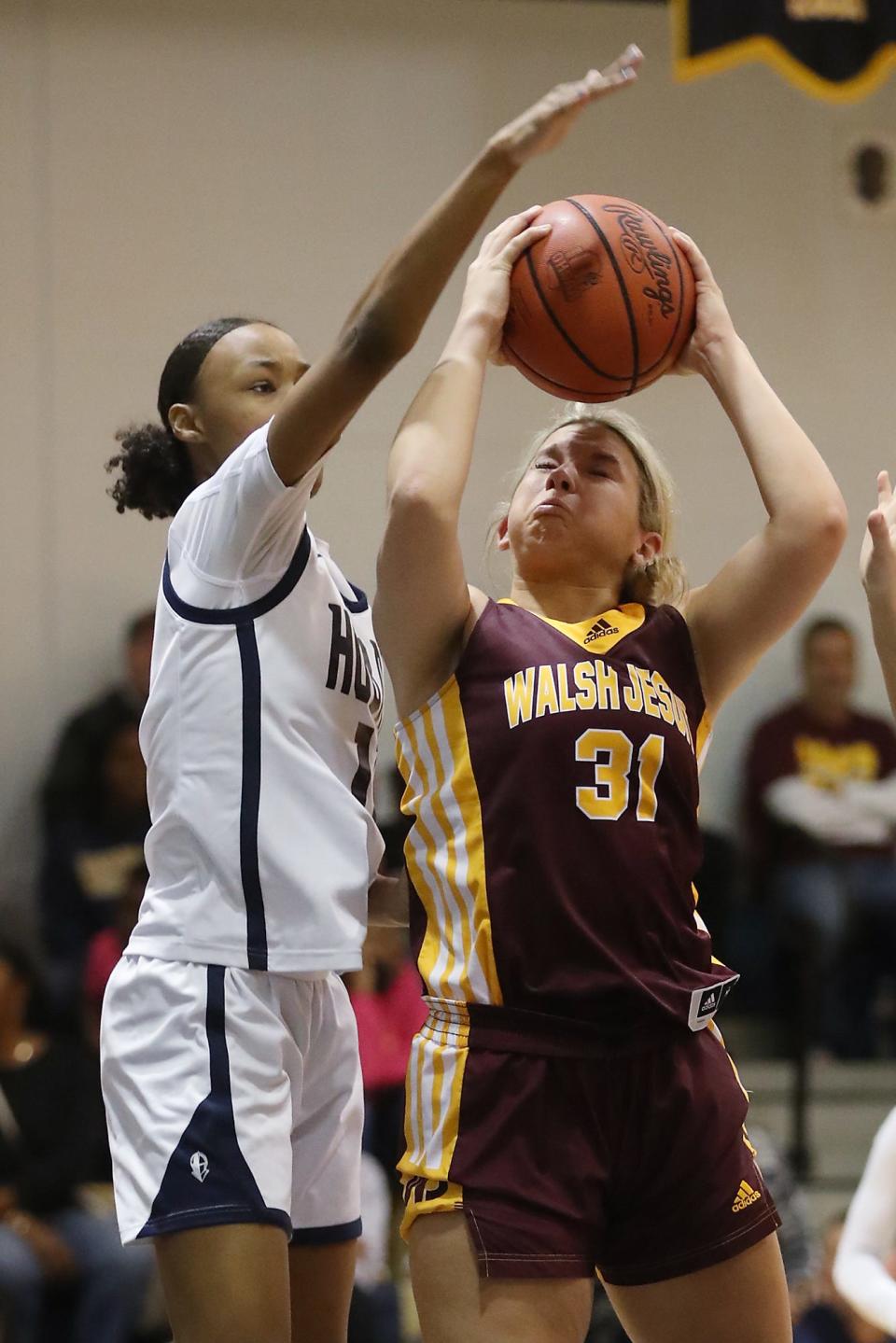 Archbishop Hoban's Devin Harris defends Walsh Jesuit's Megan Taraba on Dec. 14, 2022, in Akron.