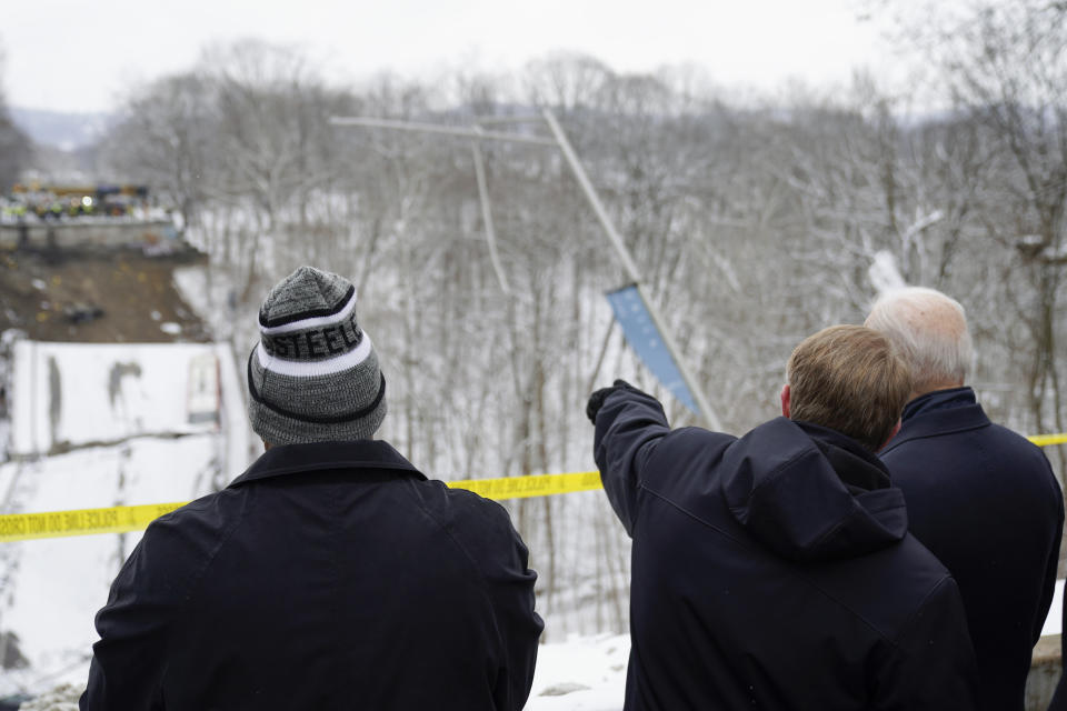 President Joe Biden visits the site where the Fern Hollow Bridge collapsed Friday, Jan. 28, 2022, in Pittsburgh's East End. Pittsburgh Mayor Ed Gainey is at left. (AP Photo/Andrew Harnik)