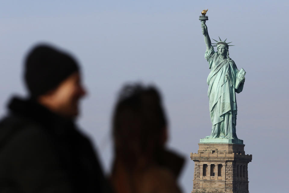 FILE - In this Jan. 21, 2018, file photo, tourists ride the Staten Island Ferry to get a view of the Statue of Liberty in New York. A new poll from The Associated Press-NORC Center for Public Affairs Research shows majorities of Americans agree that diversity is a strength and that values such as constitutional rights, a fair judicial system and the American Dream are key to the nation’s identity. But the poll shows Americans are closely split over whether it’s better for immigrants to embrace a single U.S. culture or add their own variations to the mix. (AP Photo/Mark Lennihan, File)
