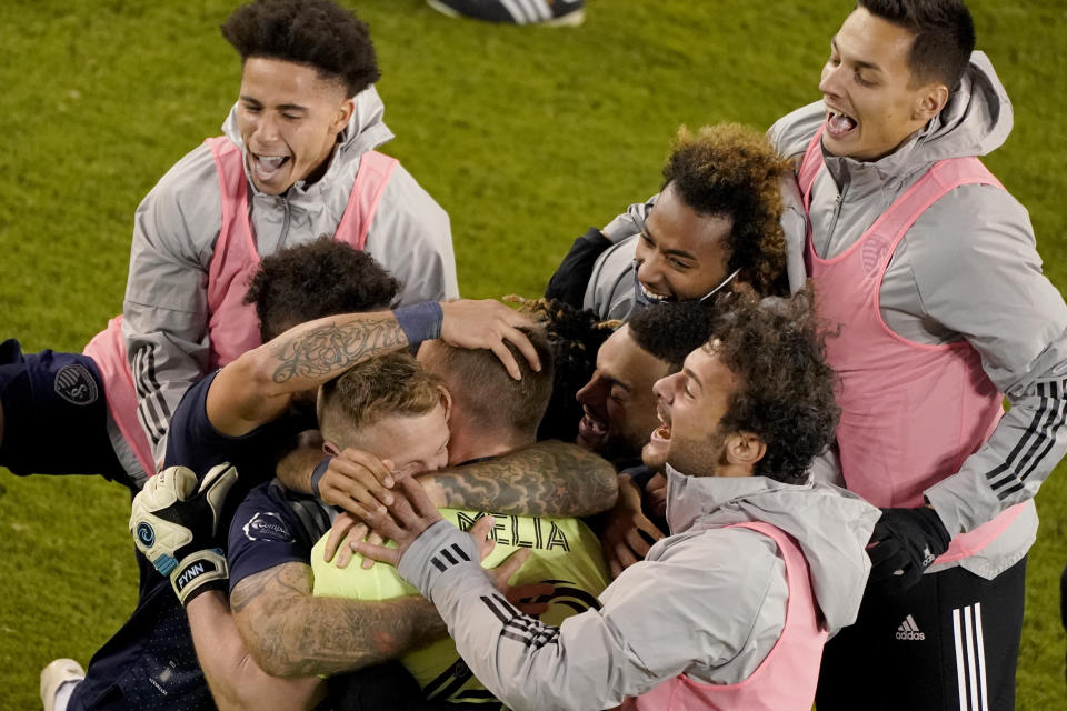 Sporting Kansas City players celebrate after winning an MLS soccer match against the San Jose Earthquakes with a penalty kick in overtime Sunday, Nov. 22, 2020, in Kansas City, Kan. (AP Photo/Charlie Riedel)