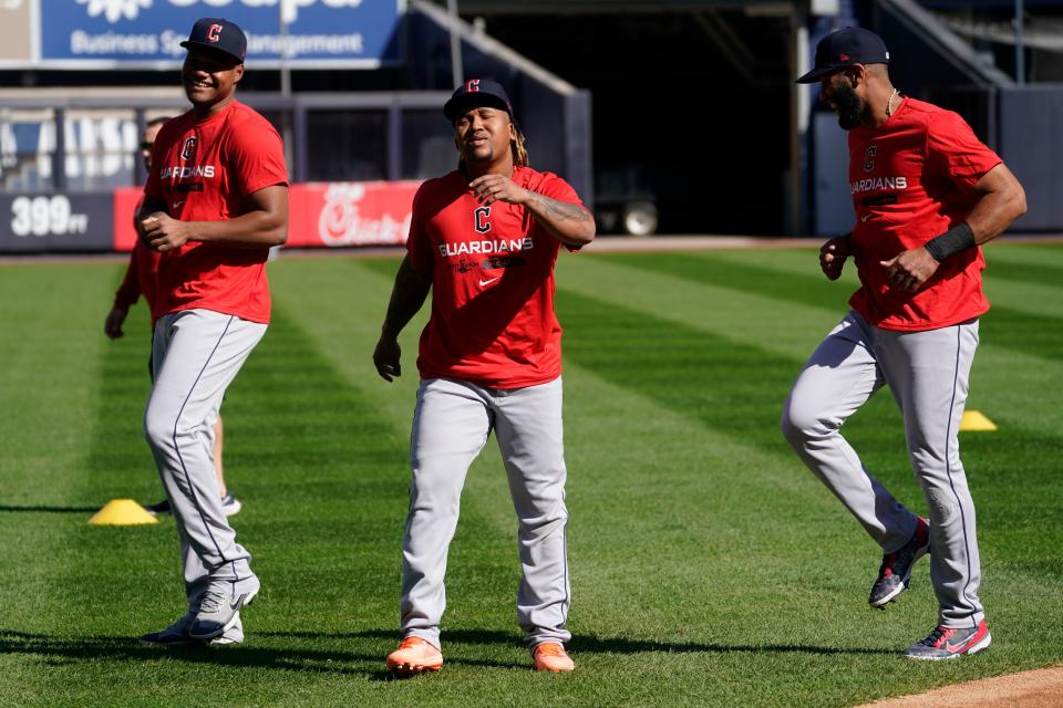 Cleveland Guardians' Jose Ramirez, center, Amed Rosario, right, and Oscar Gonzalez, left, work out ahead of Game 1 of baseball's American League Division Series against the New York Yankees, Monday, Oct. 10, 2022, in New York. (AP Photo/John Minchillo)