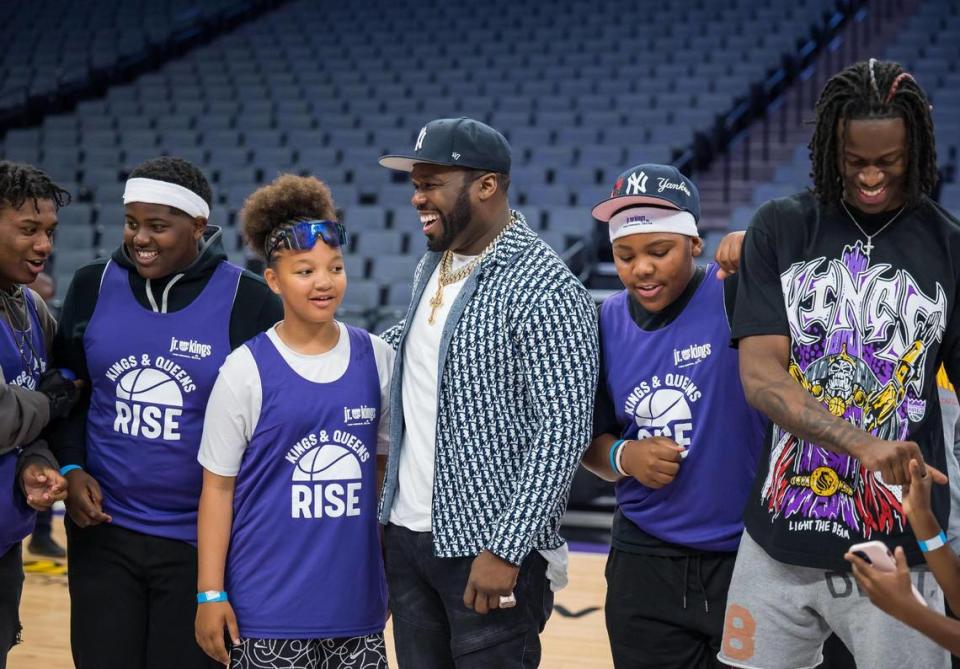 Entertainer and businessman Curtis “50 Cent” Jackson, center, is flanked by 11-year-old Ayanah Mims, left, and 13-year-old Keshawn Stone, both representing Valley Hi, as they are photographed alongside Sacramento Kings guard Keon Ellis during an event presented by Jackson’s G-Unity Foundation at Golden 1 Center on Saturday, June 10, 2023, to kick off the sixth season of the Kings and Queens Rise Co-Ed Youth Sports and Mentoring League. “It’s fun … you get to meet new people and get new friends,” Mims said about basketball, adding she’s been playing since she was 2 years old. The league, a partnership with The Center at Sierra Health Foundation’s Black Child Legacy Campaign and My Brother’s Keeper Sacramento, aims to prevent violence and create positive connections by engaging youth from eight neighborhoods in activities during the summer months. Xavier Mascareñas/xmascarenas@sacbee.com