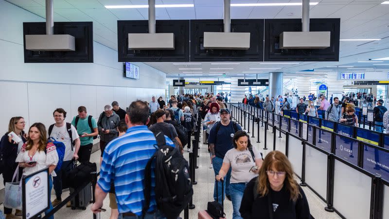 Travelers walk through security at the Salt Lake City International Airport in Salt Lake City on Friday, May 19, 2023.