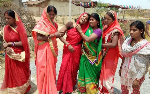  Indian relatives mourn following the rape and murder of a 16-year-old girl on May 3, at Raja Kundra Village in Chatra district