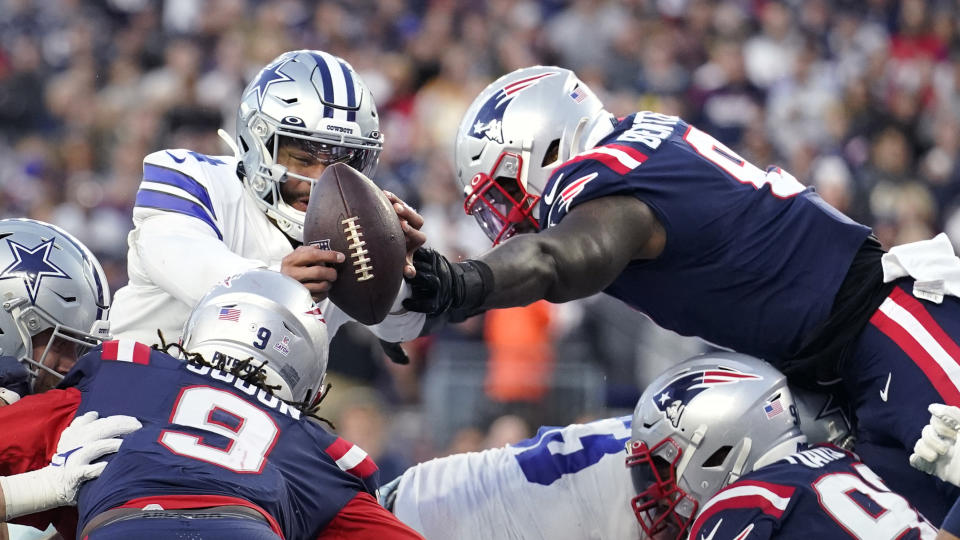 New England Patriots middle linebacker Ja'Whaun Bentley, right, knocks the ball out of the hands of Dallas Cowboys quarterback Dak Prescott, left, on a touchdown attempt at the goal line during the first half of an NFL football game, Sunday, Oct. 17, 2021, in Foxborough, Mass. (AP Photo/Steven Senne)