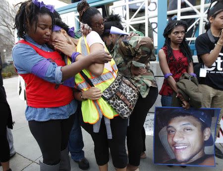 Jakayla Brown (L) comforts a crying friend during a protest over the police shooting of a man named Anthony Hill in Decatur, Georgia March 11, 2015. REUTERS/Tami Chappell