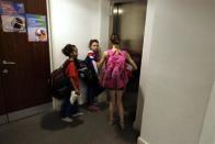 Members of Crystal Palace diving club wait for an elevator during a training session in London March 9, 2012. Standing in neat lines in a south London gym, a squad of hand-picked, track-suited youngsters stretch their arms in unison, counting together in Mandarin.Taking the proverb 'if you can't beat them, join them' quite literally, Crystal Palace diving club has turned to Chinese expertise to foster Britain's future Olympic hopes.