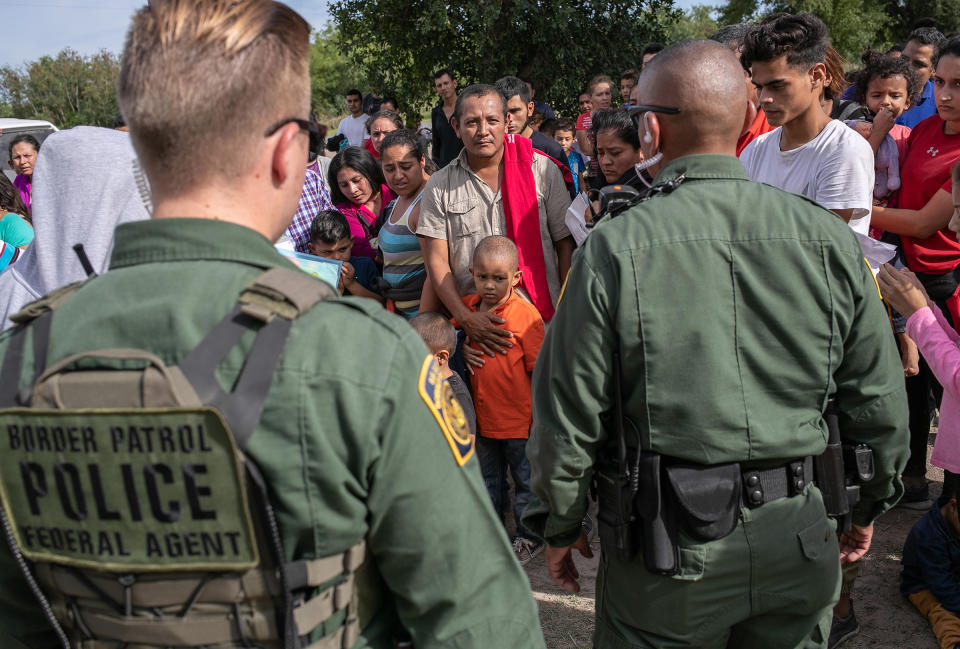 U.S. Border Patrol agents watch over immigrants after taking them into custody on July 02, 2019 in Los Ebanos, Texas. | John Moore—Getty Images