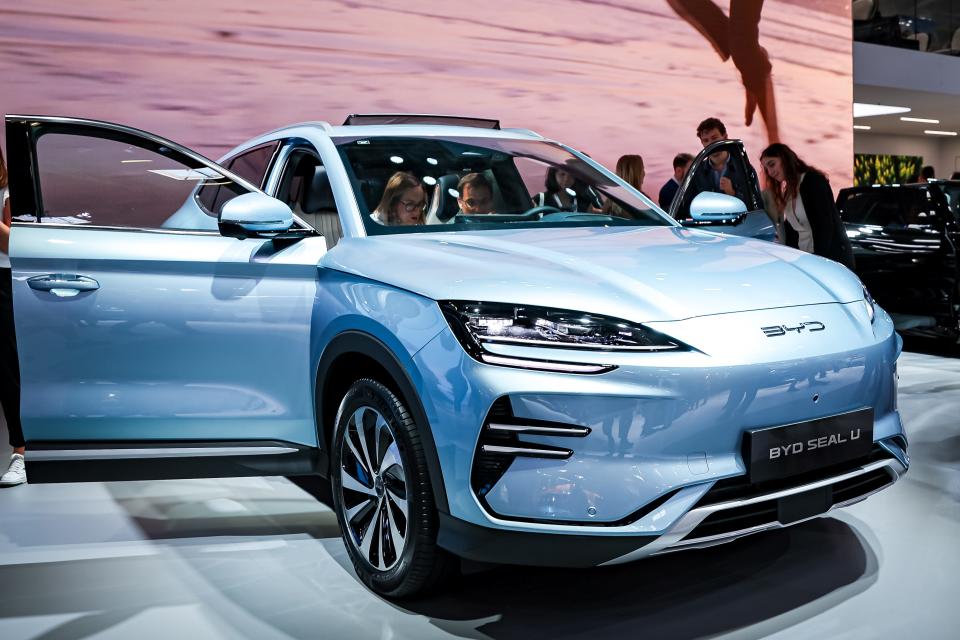 People checking out a light-blue BYD Seal U on display.