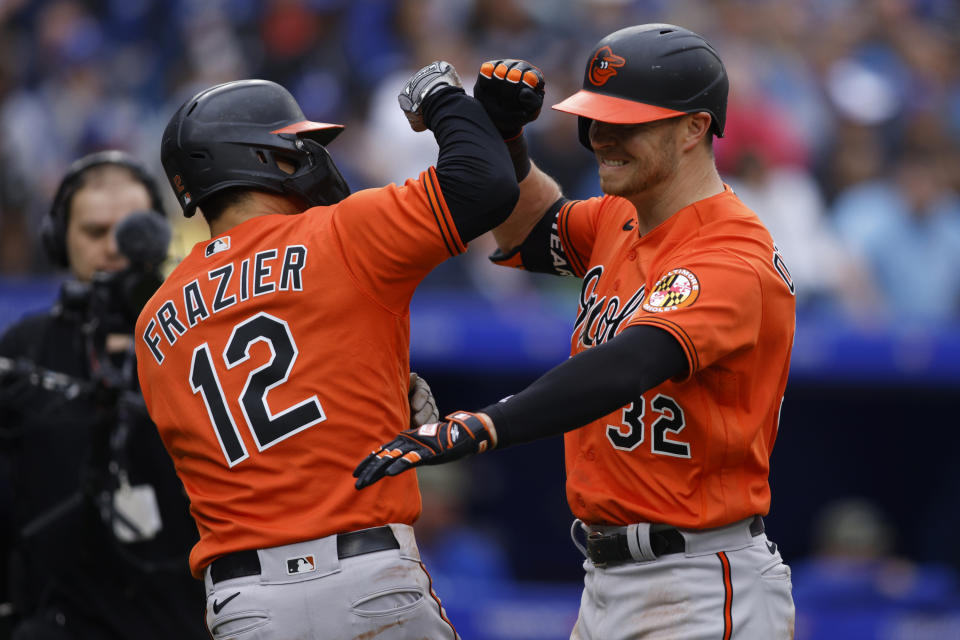 Baltimore Orioles' Ryan O'Hearn (32) celebrates his three-run home run with Adam Frazier (12) during the eighth inning of a baseball game against the Toronto Blue Jays in Toronto, Saturday, May 20, 2023. (Cole Burston/The Canadian Press via AP)