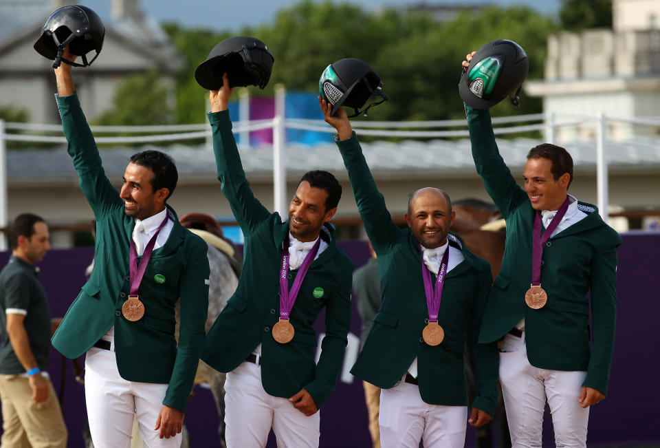 LONDON, ENGLAND - AUGUST 06: (L-R) Bronze medalists Hrh Prince Abdullah Al Saud, Kamal Bahamdan, Ramzy Al Duhami and Abdullah Waleed Sharbatly of Saudi Arabia celebrate on the podium during the medal ceremony for Team Jumping on Day 10 of the London 2012 Olympic Games at Greenwich Park on August 6, 2012 in London, England. (Photo by Alex Livesey/Getty Images)