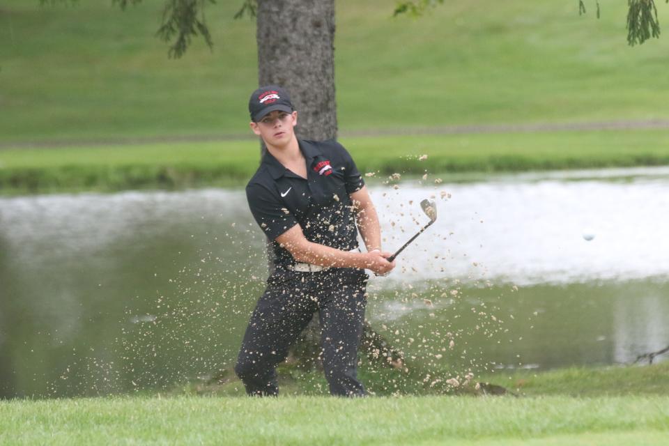 Shelby's Will Magers hits his second shot of the playoff hole out of the bunker at Twin Lakes Golf Course on Friday. Magers helped the Whippets win the team championship with a 293.