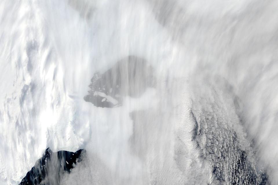 This satellite image provided by NASA, Terra MODIS 8 on March 2022 shows the original extent of C-37 through cloud next to Bowman Island. Scientists are concerned because an ice shelf the size of New York City collapsed in East Antarctica, an area that had long been thought to be stable. The collapse last week was the first time scientists have ever seen an ice shelf collapse in this cold area of Antarctica. (NASA via AP)