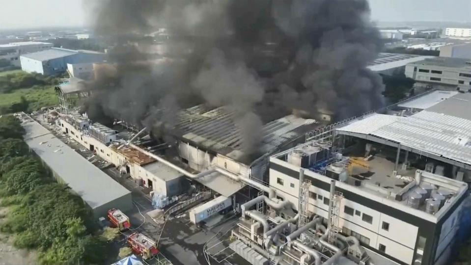 In this image made from video footage run by EBC, smoke billows from a factory of golf ball manufacturer Launch Technologies Co. in the southern county of Pingtung in Taiwan on Friday, Sept. 22, 2023. The golf ball factory fire has left multiple people killed, and the victims include several firefighters, according to Taiwanese media reports. (EBC via AP)