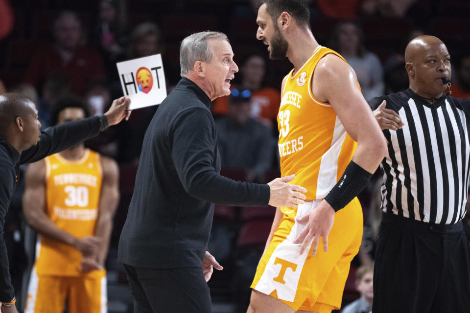 Tennessee head coach Rick Barnes, center left, communicates with forward Uros Plavsic (33) during the first half of an NCAA college basketball game against South Carolina, Saturday, Jan. 7, 2023, in Columbia, S.C. (AP Photo/Sean Rayford)