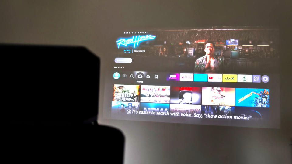 Fire TV being projected with a Fire TV Cube in the foreground.