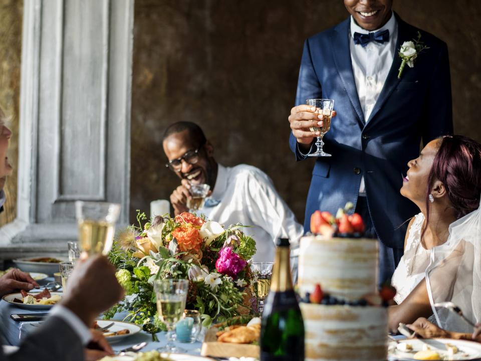 A guest gives a speech at a wedding reception.