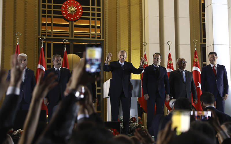Turkish President and People's Alliance presidential candidate Recep Tayyip Erdoğan, center, gestures to supporters