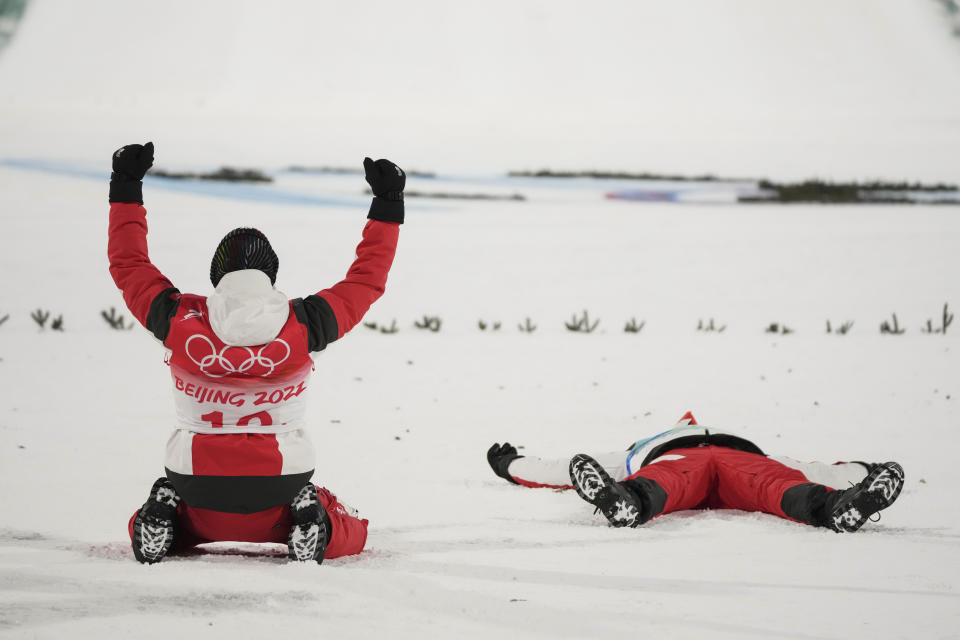 Stefan Kraft, of Austria, celebrates with teammate Daniel Huber after they won gold in the men's team ski jumping eventat the 2022 Winter Olympics, Monday, Feb. 14, 2022, in Zhangjiakou, China. (AP Photo/Matthias Schrader)