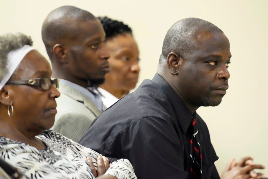 Eddie Terrell Parker, right, and Michael Corey Jenkins, center, listen as one of six former officers with the Mississippi sheriff’s department pleads guilty to state charges at the Rankin County Circuit Court in Brandon, Miss., Monday, Aug. 14, 2023. (AP Photo/Rogelio V. Solis, File)