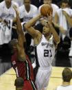San Antonio Spurs' Tim Duncan (R) shoots over Miami Heat's Chris Bosh during the first quarter in Game 1 of their NBA Finals basketball series in San Antonio, Texas June 5, 2014. REUTERS/Mike Stone (UNITED STATES - Tags: SPORT BASKETBALL)