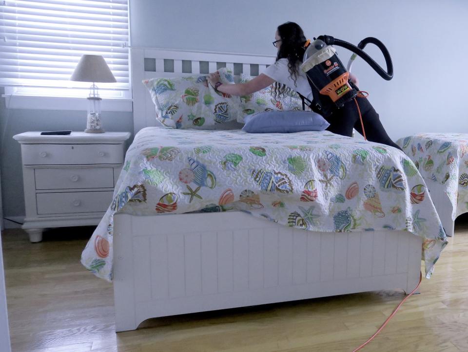 LBI Cleaning employee Cassie Jones, Mayetta, straightens pillows in a Surf City home the crew was cleaning Thursday, June 16, 2022.  The company now has six employees, but it needs 30 for the summer season.