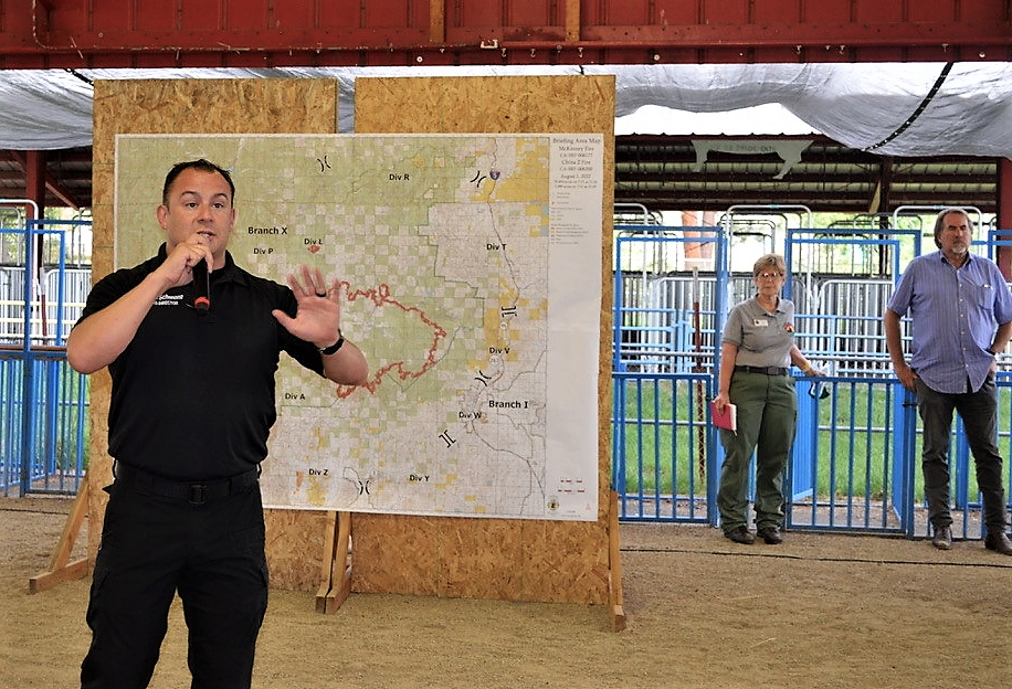Brian Schenone, director of the Siskiyou County Office of Emergency Services, addresses the crowd gathered at the Siskiyou Golden Fair grounds on Monday, Aug. 1, 2022, to hear updates on the McKinney Fire. At far right is Rep. Doug LaMalfa, R-Richvale, who also spoke to the residents.