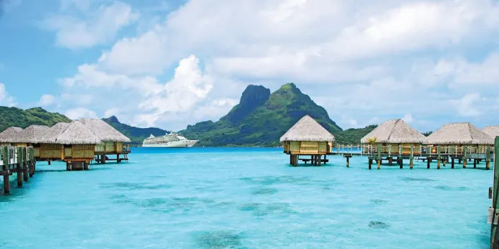 Structures suspended over clear blue waters in Fiji.