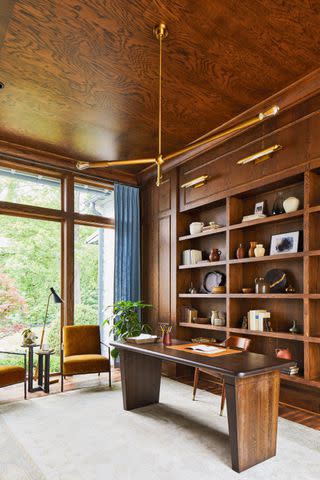 <p>Laurey W. Glenn; Stylist: Matthew Gleason</p> Ceiling-high windows bookend this intermediary space between the great room and the primary bedroom, flooding the oak-paneled study with natural light.