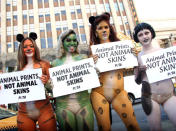 Protesters hold signs during PETA's animal skin protest for the holiday season at Hollywood and Highland on December 23, 2011 in Hollywood, California. (Photo by Tommaso Boddi/Getty Images)