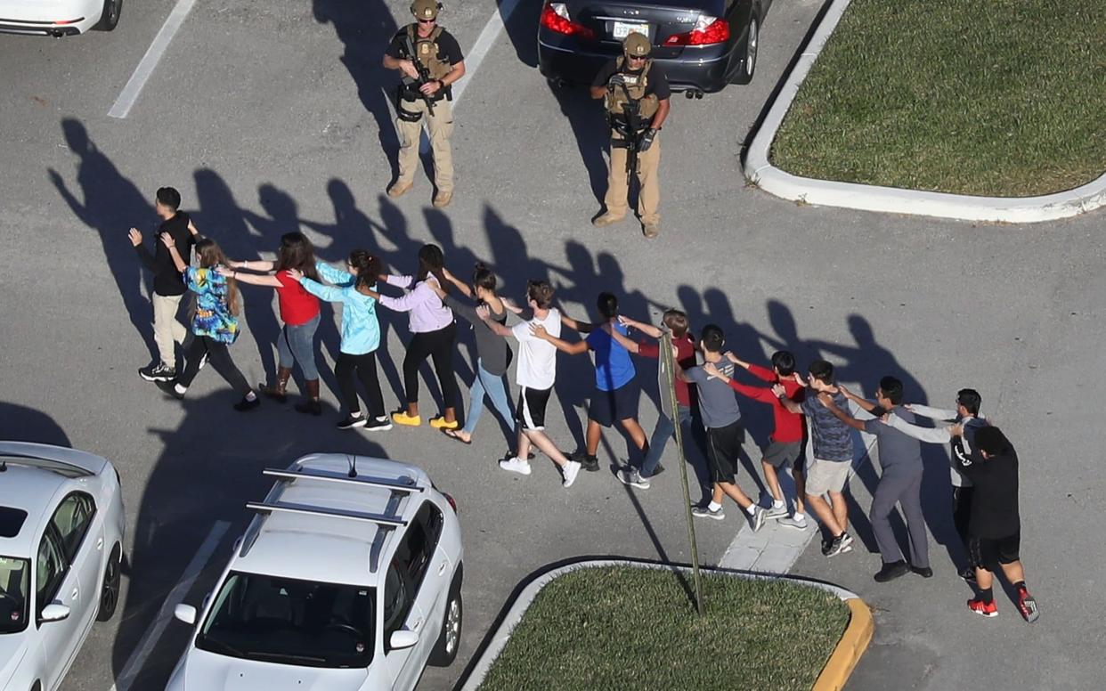 Students are lead out of high school in Florida after mass shooting - Getty Images North America