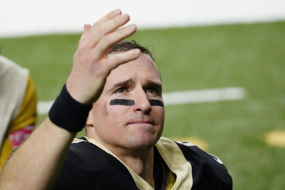 New Orleans Saints quarterback Drew Brees waves to his family and fans after his final NFL game, a playoff loss to the Buccaneers. (AP Photo/Brynn Anderson)