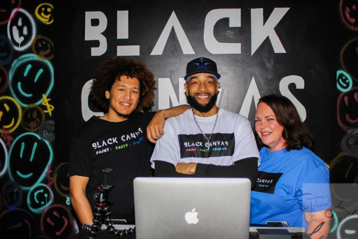 Thomas Ferguson, left, Bernard Mention, aka DJ Wolfe, and Susan Stinchfield are the team behind Black Canvas, an art space located on Bragg Boulevard in Eutaw Shopping Center in Fayetteville, NC.
