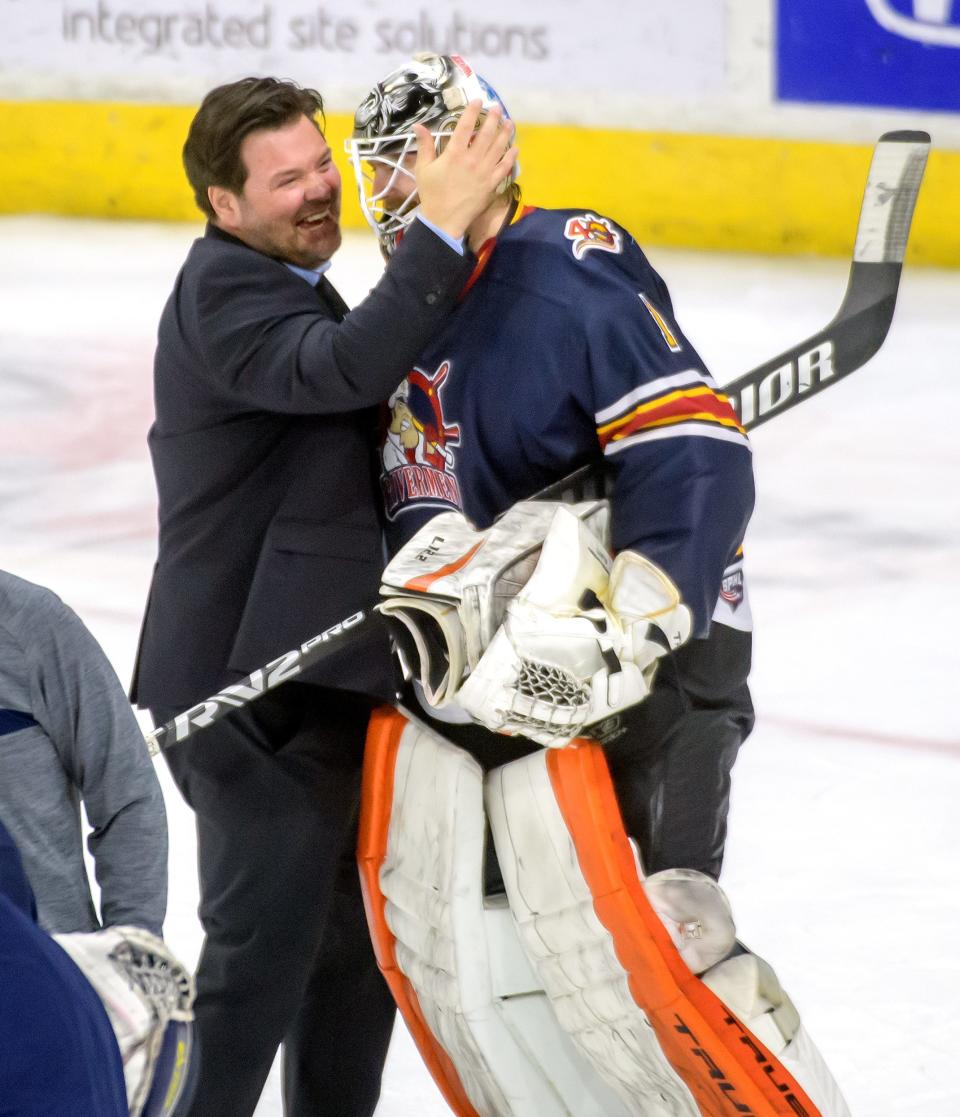 Peoria head coach Jean Guy-Trudel, left, congratulates goaltender Jack Berry after their 3-2 win over the Quad City Storm in Game 3 of the SPHL semifinals Saturday, April 23, 2022 at Carver Arena in Peoria. The Rivermen advance to the finals against the Roanoke Rail Yard Dawgs.