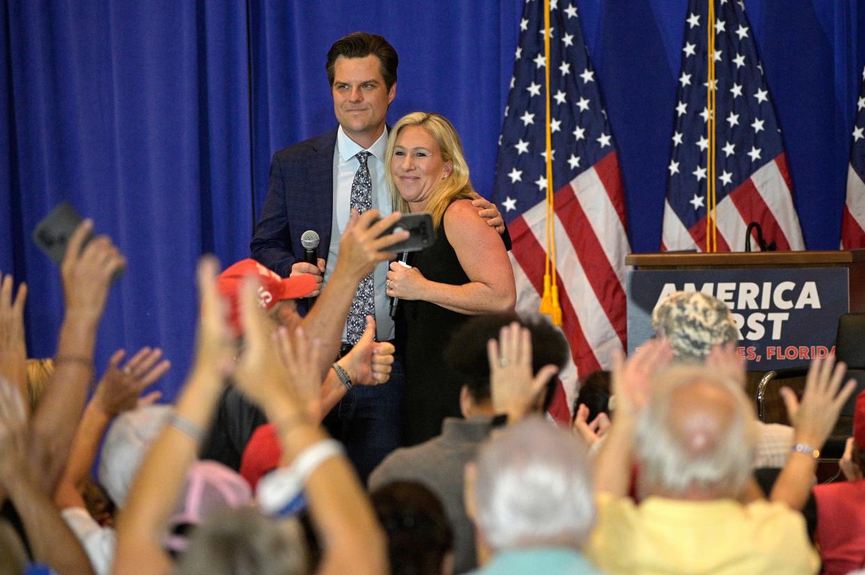 Republican representatives Matt Gaetz and Marjorie Taylor Greene hug after an ‘America First' rally in Florida (AP)