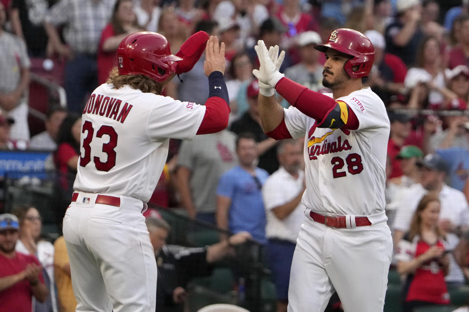 St. Louis Cardinals' Nolan Arenado (28) is congratulated by teammate Brendan Donovan (33) after hitting a two-run home run during the first inning of a baseball game against the Cincinnati Reds Friday, June 9, 2023, in St. Louis. (AP Photo/Jeff Roberson)