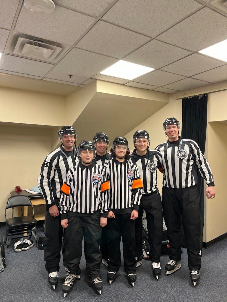 Cooper and Phillips pose with NHL officials.