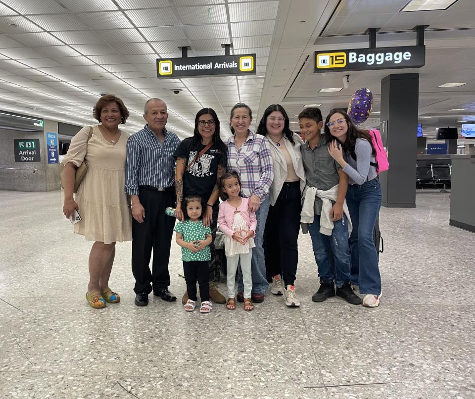 Returning to the U.S. gave Laura Meza a chance to reunite with her family and meet her granddaughter. / Credit: Camilo Montoya-Galvez / CBS News