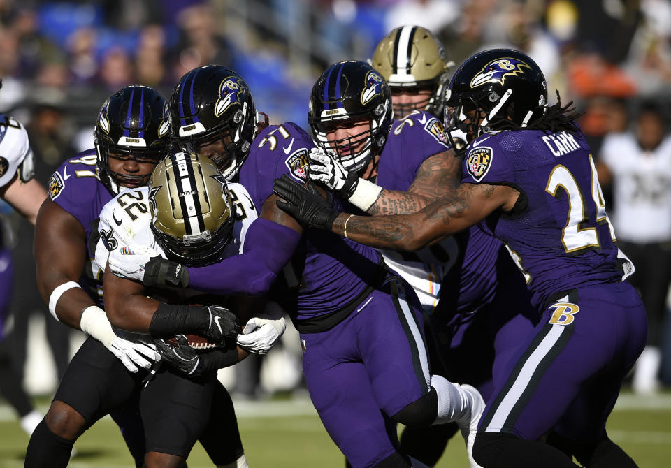 New Orleans Saints running back Mark Ingram (22) is tackled by a group of Baltimore Ravens defenders as he rushes the ball in the first half of an NFL football game, Sunday, Oct. 21, 2018, in Baltimore. (AP Photo/Nick Wass)