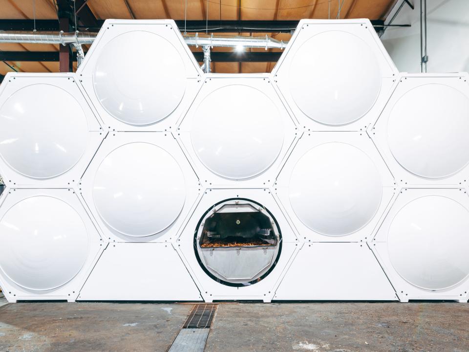 Composting pods are shown here. They are circular fitting together in a hexagonal pattern, similarly to a bee hive.