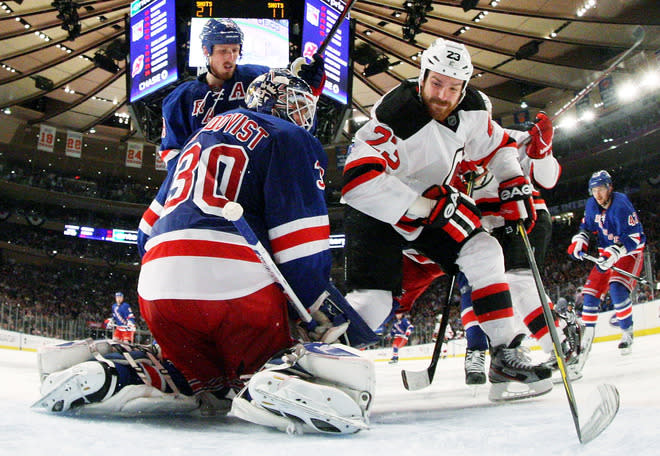 NEW YORK, NY - MAY 23: Henrik Lundqvist #30 of the New York Rangers defends against David Clarkson #23 of the New Jersey Devils in the third period of Game Five of the Eastern Conference Final during the 2012 NHL Stanley Cup Playoffs at Madison Square Garden on May 23, 2012 in New York City. (Photo by Bruce Bennett/Getty Images)