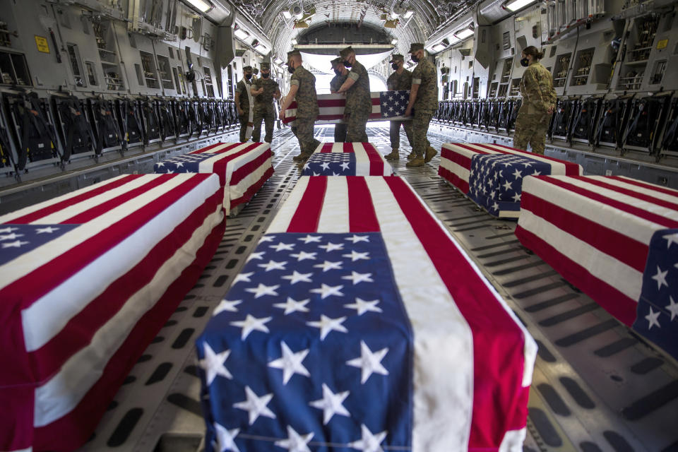 FILE - In this Aug. 12, 2020, file photo, provided by the U.S. Marine Corps, U.S. Marines and sailors carry a casket inside a U.S. Air Force C-17 Globemaster III at Marine Corps Air Station Miramar, in Calif., Wednesday, Aug. 12, 2020. The remains included seven Marines and a sailor, who died after a seafaring tank sank off the coast of Southern California last month, were transferred to Dover Air Force Base in Delaware for burial preparations. The U.S. Marine Corps is expected to release results of its investigation into a seafaring tank that sunk off San Diego's coast last summer, killing eight Marines and one sailor. (Lance Cpl. Brendan Mullin/U.S. Marine Corps via AP, File)