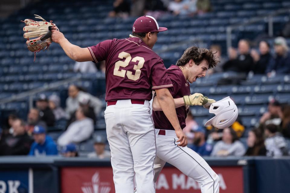 Shepherd Hill's Angel Paulino, left, and Andrew Lancette celebrate after Lancette scored in the seventh inning.