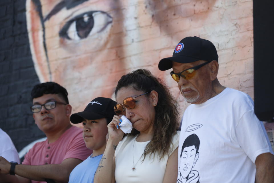 Elizabeth Toledo, center, mother of of police shooting victim 13-year-old Adam Toledo, wipes jer tears during a news conference announcing the opening of Adam's Place Inc., a not-for profit organization aiming to help at-risk youth from Chicago and other Midwestern cities to remain out of trouble, Wednesday, May 26, 2021 in Chicago's West Side. (AP Photo/Shafkat Anowar)