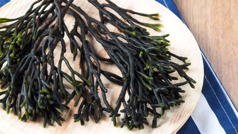 Codium seaweed on wooden board