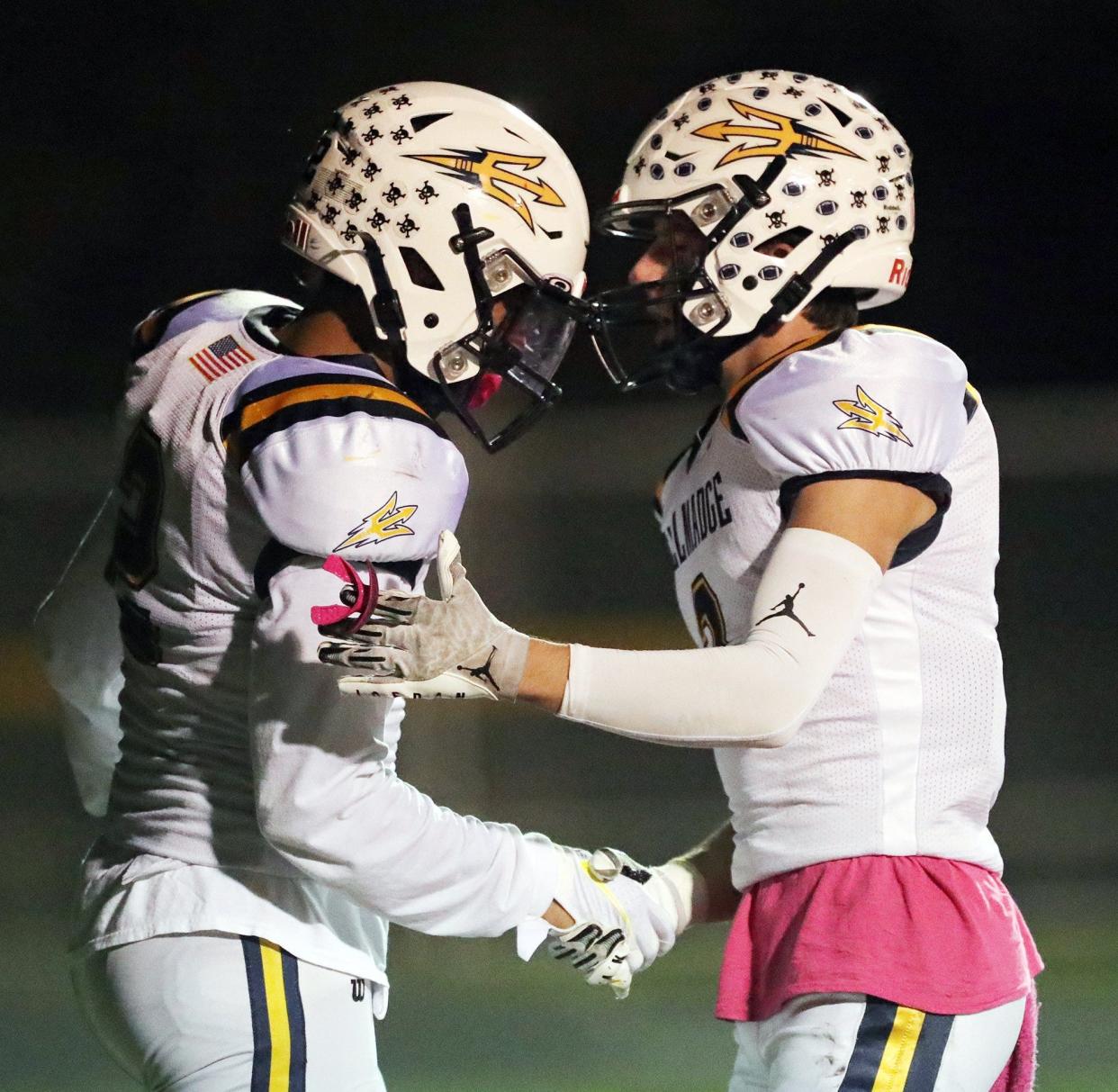 Tallmadge wide receiver Collin Dixon, left, shakes hands with teammate Mason Dexter after scoring during the first half of a high school football game against the Copley Indians, Friday, Oct. 15, 2021, in Copley, Ohio. [Jeff Lange/Beacon Journal]