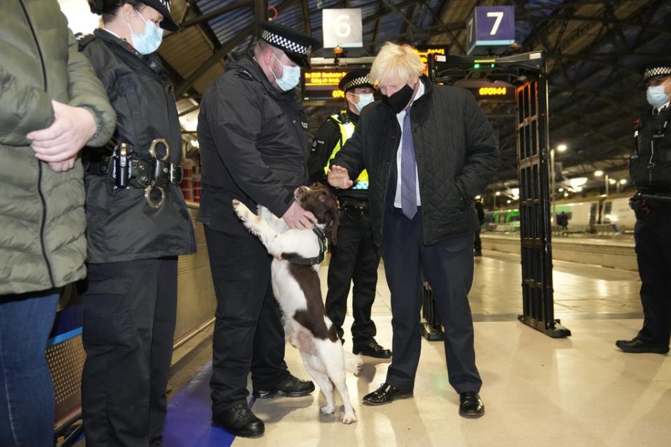 Boris Johnson talks to British Transport Police officers and police dog Ozzy at Liverpool Lime Street station (Christopher Furlong/PA) (PA Wire)