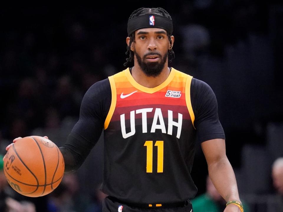 Mike Conley dribbles the ball up the court during a game.