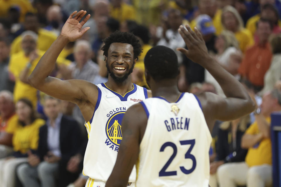 Golden State Warriors forward Andrew Wiggins, left, celebrates with forward Draymond Green during Game 5 of the 2022 NBA Finals against the Boston Celtics at Chase Center in San Francisco on June 13, 2022. (AP Photo/Jed Jacobsohn)